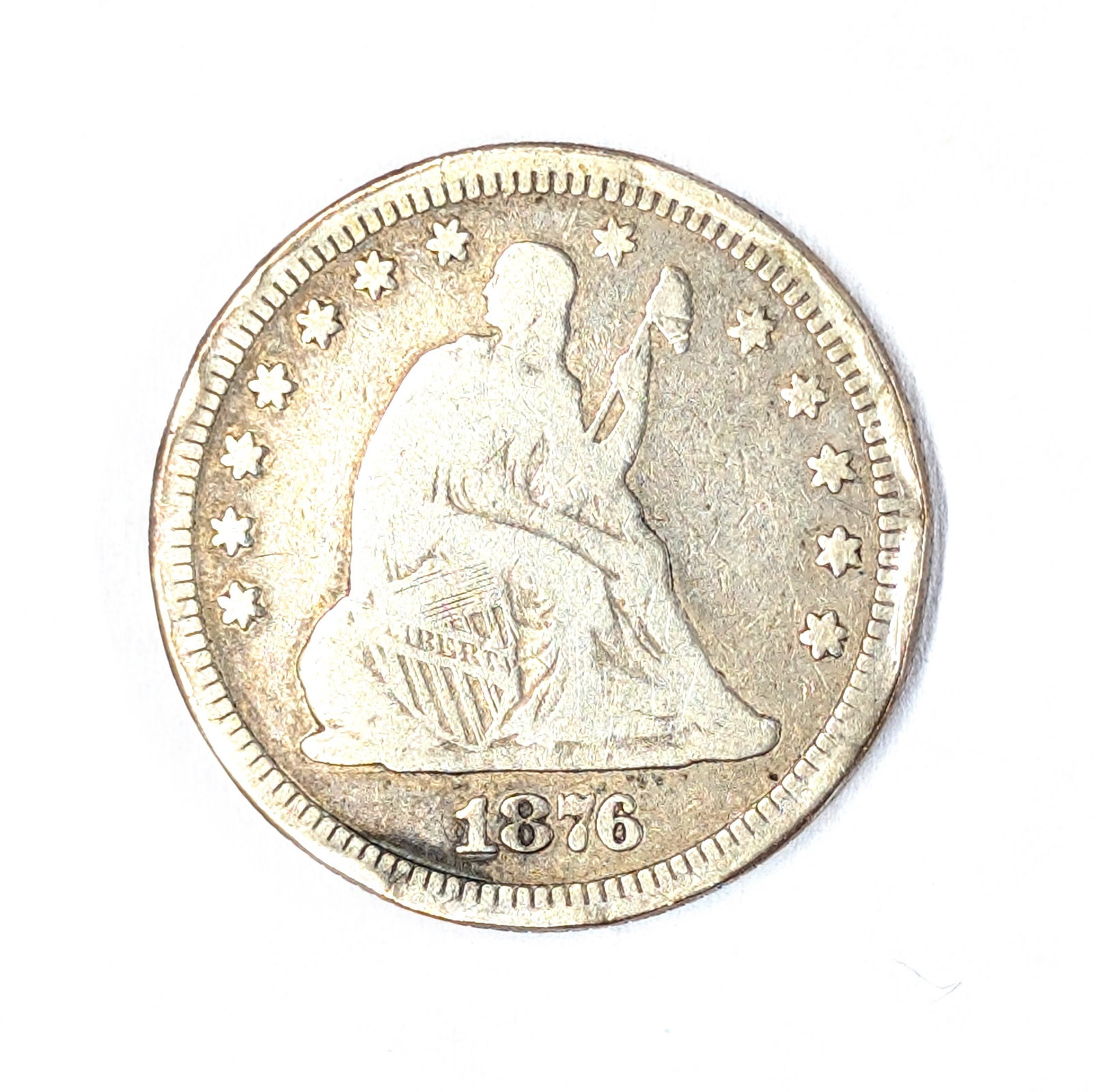1876 Toned Silver Seated Quarter: rim appears "smushed' in some spots