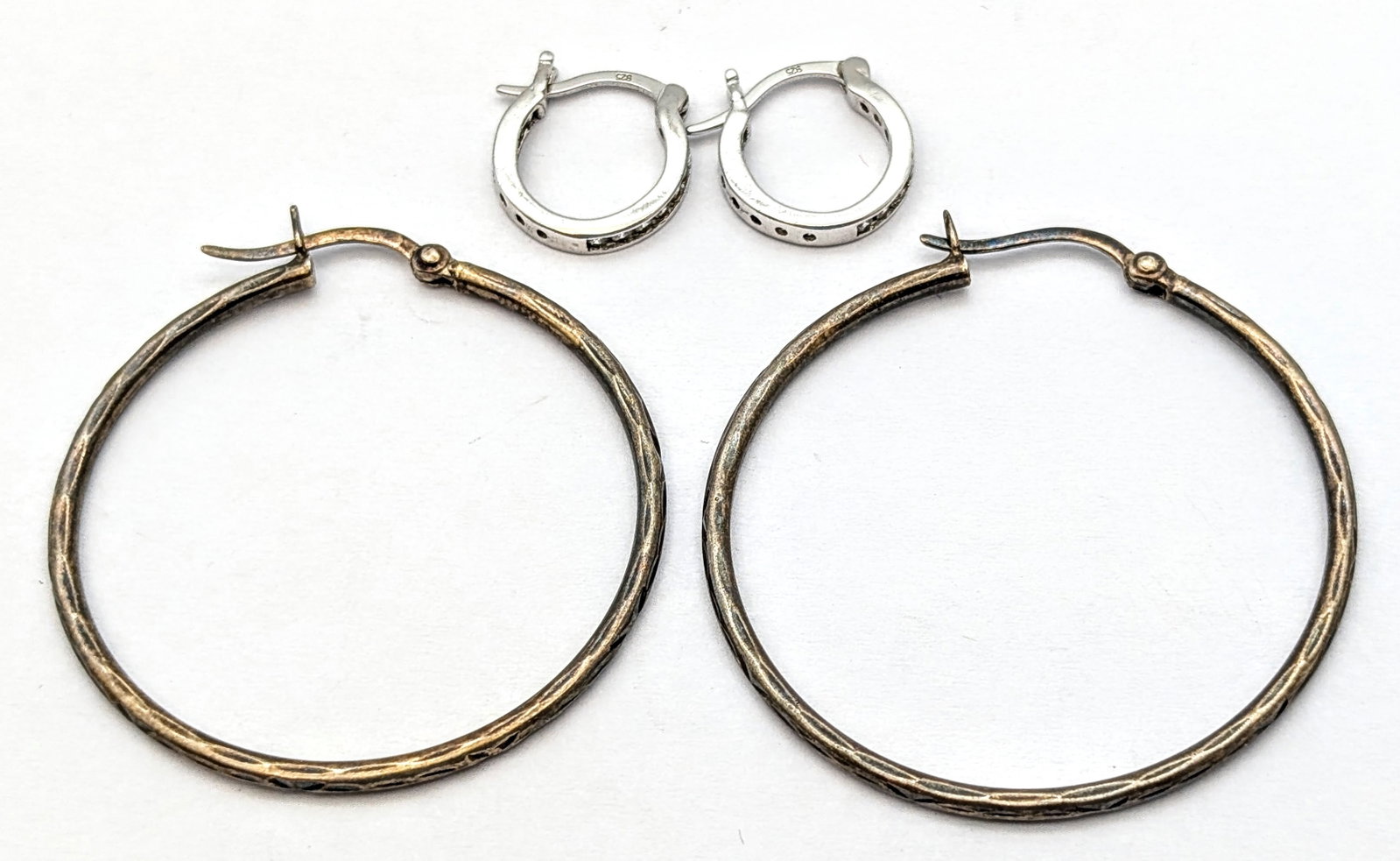Lot of 2 Sterling Silver Hoop Earrings: _