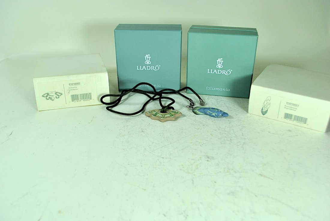 2 Pieces of Lladro Jewelry: 2 pieces of Lladro jewelry - 'Providence' pin & 'Harmony' pendant on silk rope chain, both retired, w/original pouches, boxes and sleeves.