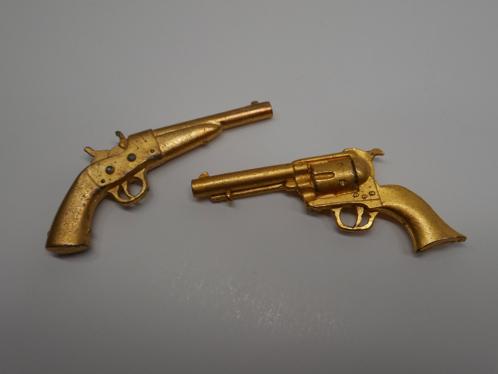 Two Gold Painted Miniature Metal Gun, Pistol, Revolver Models, 2.5 inches: Bidding on this item will be indication that the Bidder acknowledges that they have read and agreed to the Terms and Conditions posted to this Auction