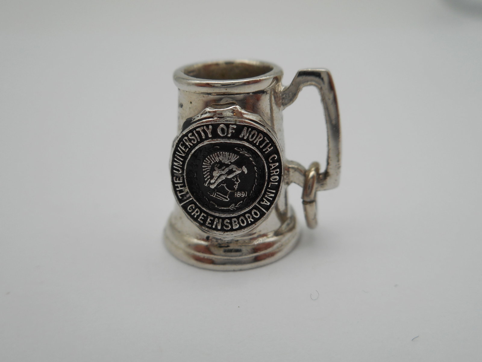 Silver Beer Stein Charm - University of North Carolina, Greensboro, Glass Bottom, 1/2 inch: Bidding on this item will be indication that the Bidder acknowledges that they have read and agreed to the Terms and Conditions posted to this Auction
