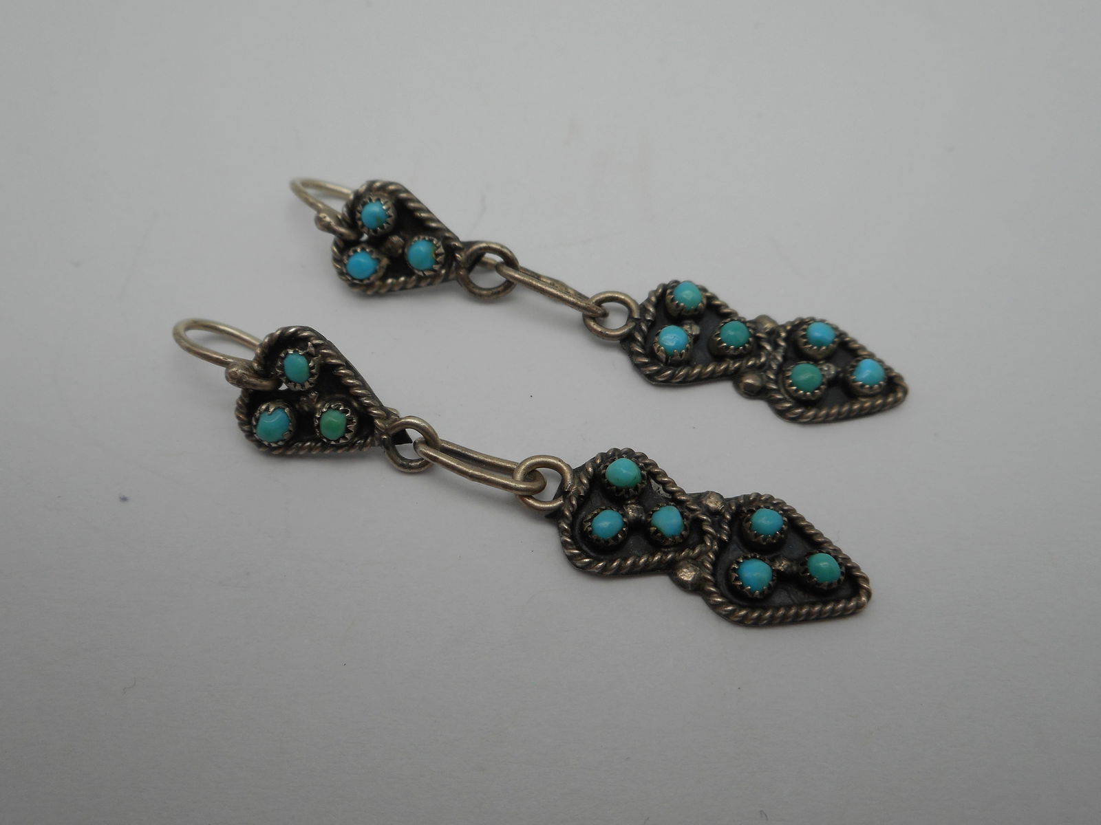 Southwestern Zuni Style Sterling Silver Dangle Heart earrings, Unmarked, Robins Egg Turquoise seeds: about 2 inches long Bidding on this item will be indication that the Bidder acknowledges that they have read and agreed to the Terms and Conditions posted to this Auction