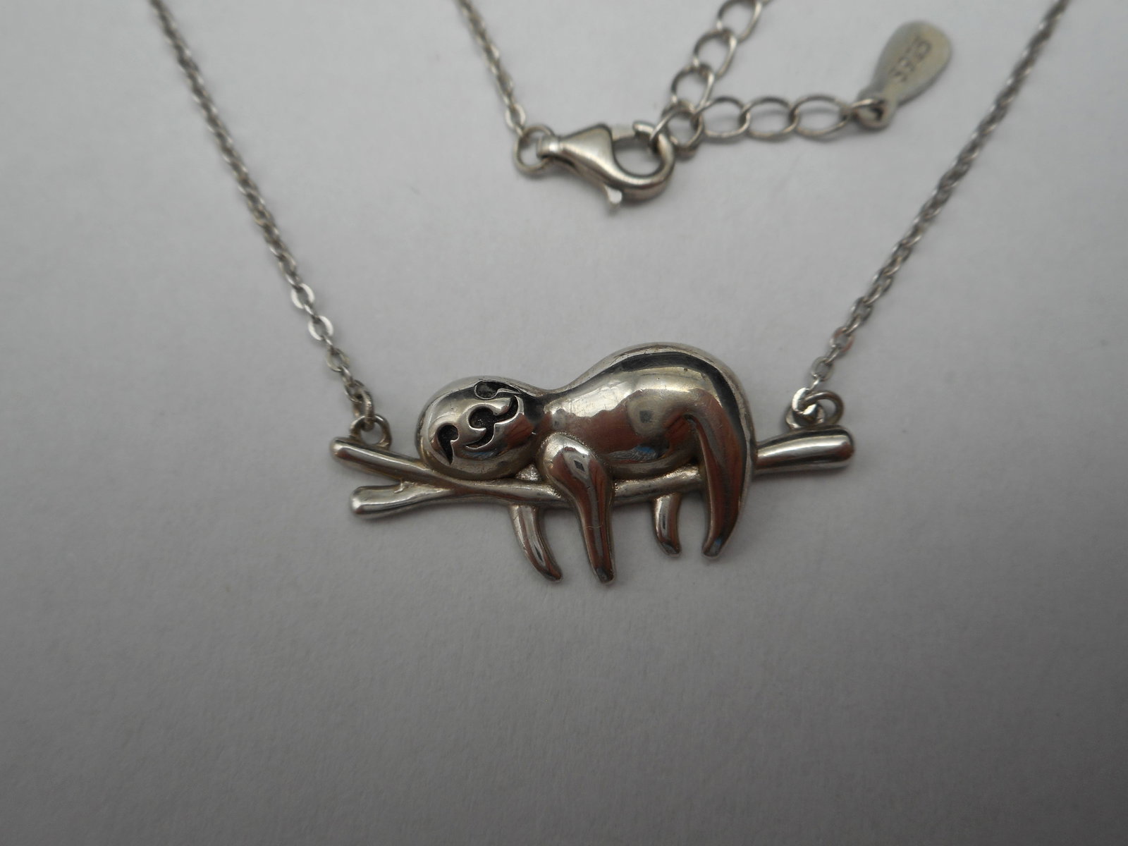 Sweet Sloth Lounging on Branch, Fixed 925 Silver Charm on 925 Necklace, 20 inches long: Bidding on this item will be indication that the Bidder acknowledges that they have read and agreed to the Terms and Conditions posted to this Auction