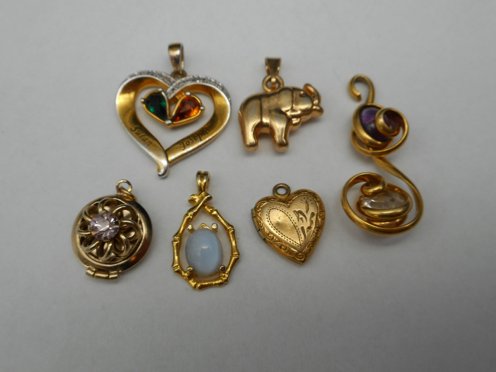 Variety of Pretty Charms and Pendants, Including Lockets, Some Stones: Bidding on this item will be indication that the Bidder acknowledges that they have read and agreed to the Terms and Conditions posted to this Auction