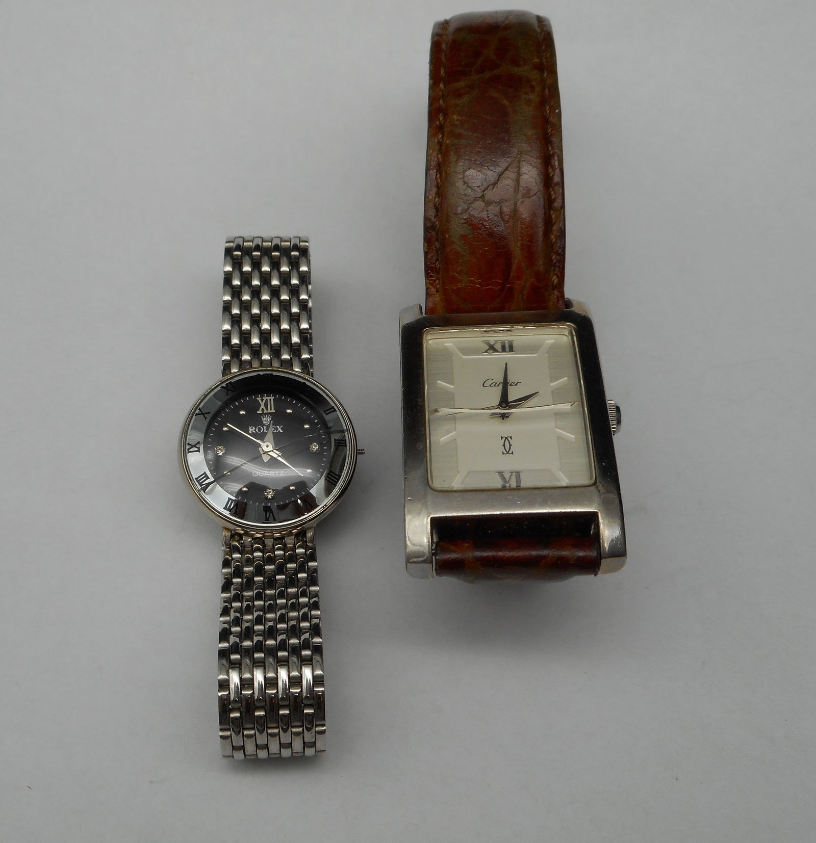 Pair of Vintage Wrist Watches, Cracked Glass, Need repairs, Designer Replicas, Fashion Watches: Watches are not authenticated Bidding on this item will be indication that the Bidder acknowledges that they have read and agreed to the Terms and Conditions posted to this Auction