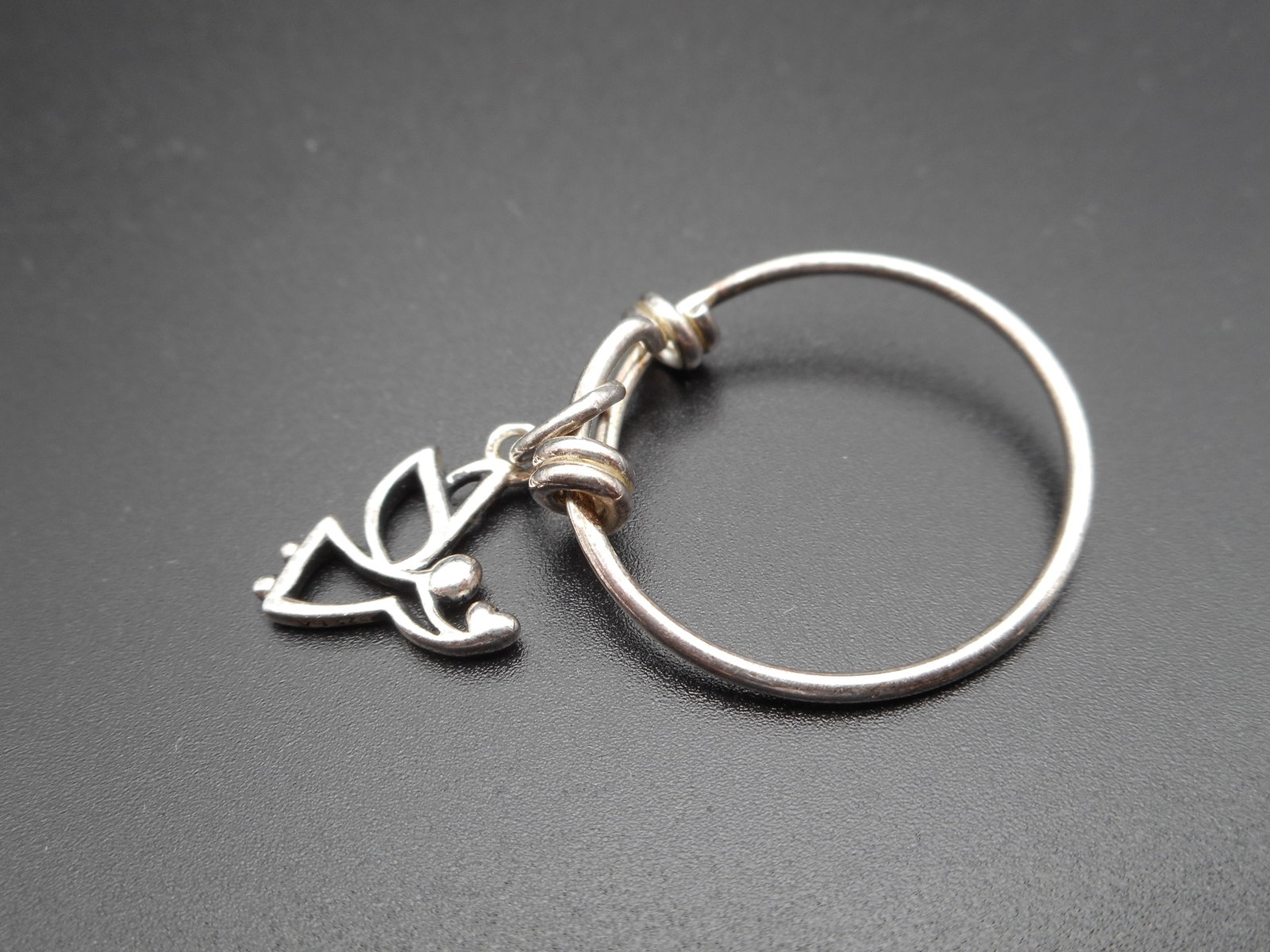 Sterling Silver Wire Ring with Bypass Knots, Angel Dangle Charm, Marked 925, Size 9.5: Bidding on this item will be indication that the Bidder acknowledges that they have read and agreed to the Terms and Conditions posted to this Auction