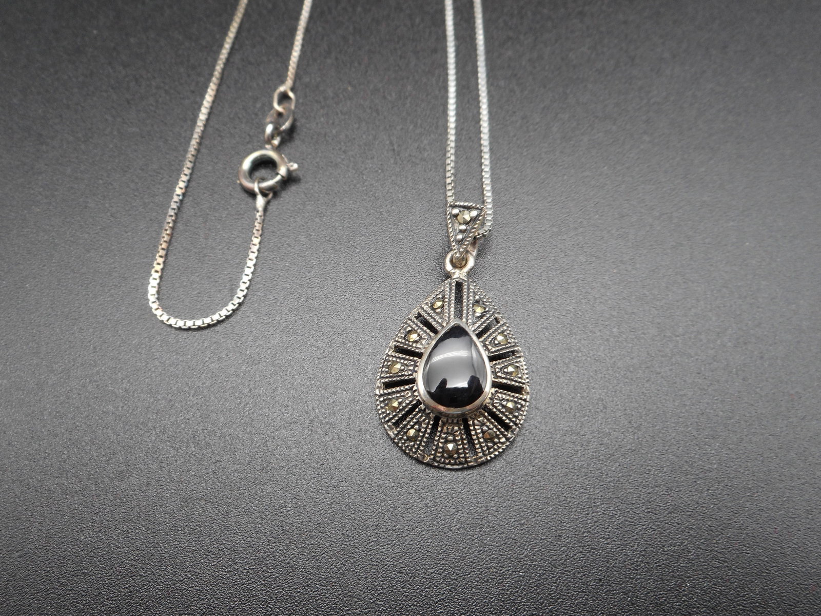 Sterling Silver, Black Onyx and Marcasite Teardrop 3/4-inch Pendant on 18-inch Necklace, Marked 925: Bidding on this item will be indication that the Bidder acknowledges that they have read and agreed to the Terms and Conditions posted to this Auction