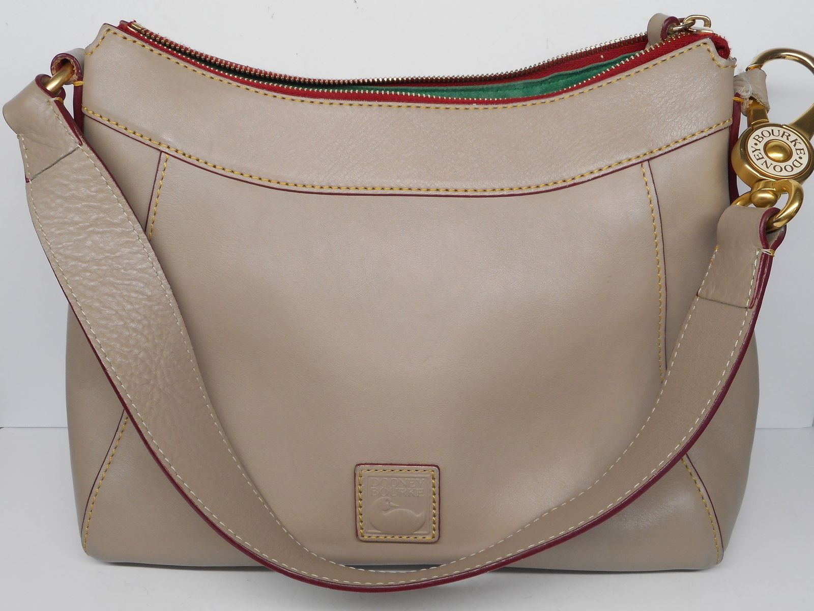 Dooney & Bourke Large Florentine Hobo Cassidy Shoulder Bag, Florentine Vacchetta Leather, Pre-Loved: No COA, please review photos carefully for condition and details. Interior lining has many pen marks, tag with Serial number, Made in China Bidding on this item will be indication that the Bidder ackn