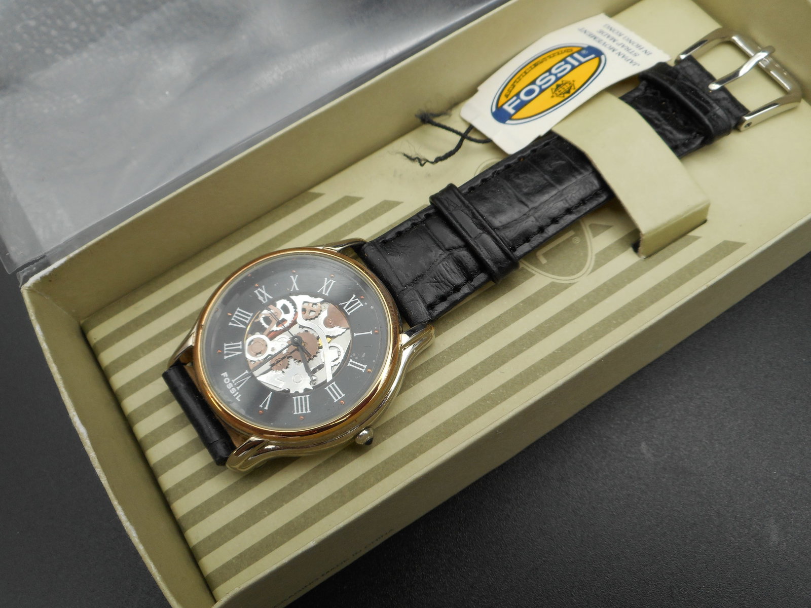 Vintage FOSSIL Men's Skeleton Watch, Exposed Gears, Black Leather band, In Box, May Need Battery: box worn from storage Bidding on this item will be indication that the Bidder acknowledges that they have read and agreed to the Terms and Conditions posted to this Auction