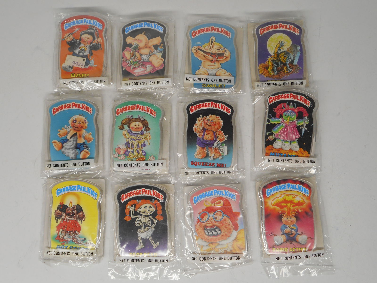 1986 Topps Garbage Pail Kids Button Full Set of 12, New in Package: Bidding on this item will be indication that the Bidder acknowledges that they have read and agreed to the Terms and Conditions posted to this Auction