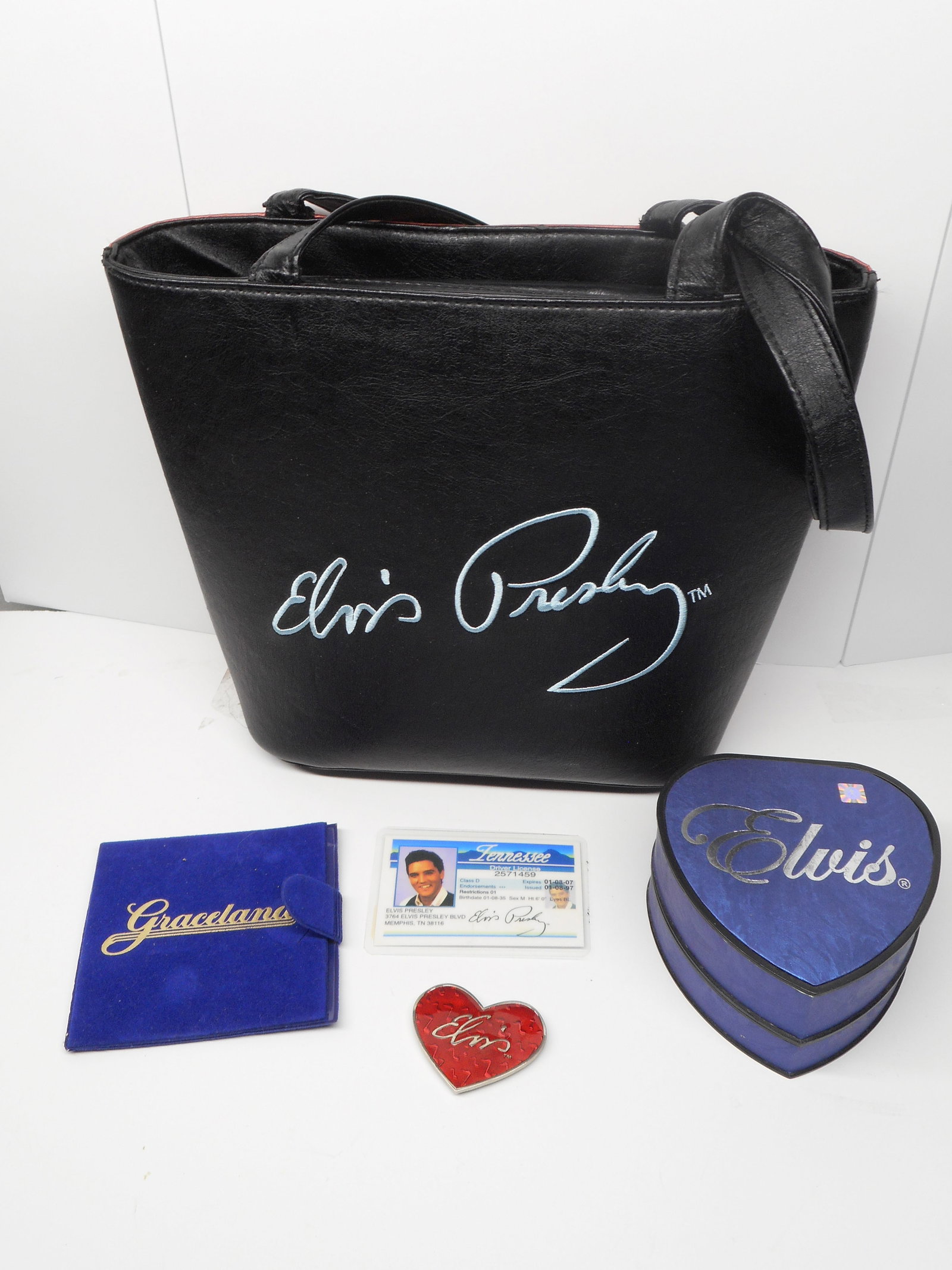 Elvis Presley Accessory Lot - Embroidered Purse, Souvenir License, Watch Box (empty) and more: Purse has some wear on straps Bidding on this item will be indication that the Bidder acknowledges that they have read and agreed to the Terms and Conditions posted to this Auction