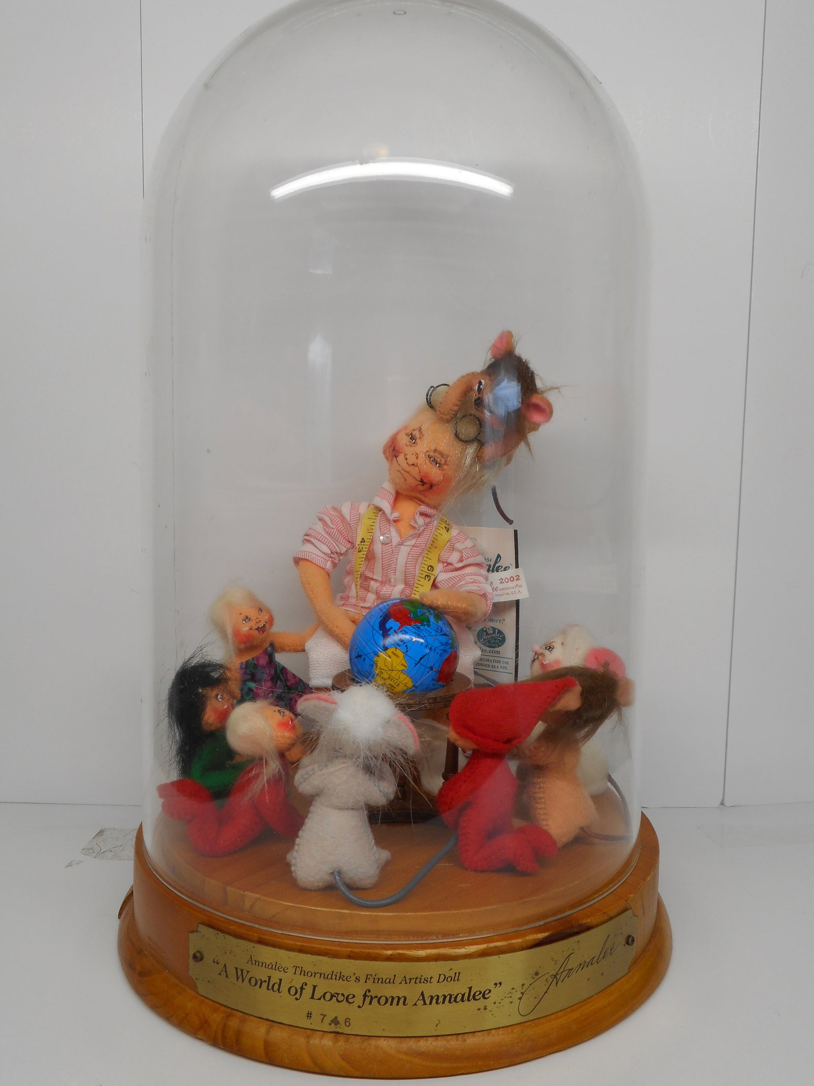 Signed Annalee A World of Love with Wooden Base and Glass Dome, Numbered Plaque #746, Karen & Chuck: Signed by Karen and Chuck Thorndike. Additional handling fee will apply for shipping Bidding on this item will be indication that the Bidder acknowledges that they have read and agreed to the Terms an