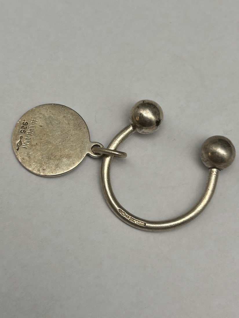 Horseshoe Keyring, Engravable Round Charm, Says Hamilton, Marked 925, Sterling, Makers Mark: Keyring approx. 1.25-inches Bidding on this item will be indication that the Bidder acknowledges that they have read and agreed to the Terms and Conditions posted to this Auction