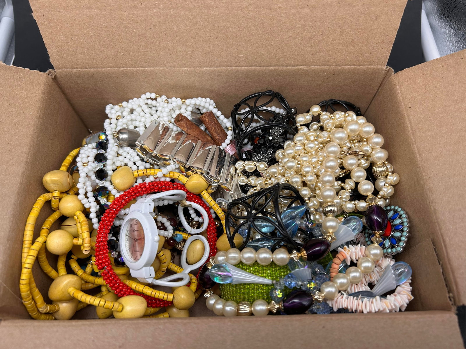 9 x 6" Box loaded with Mostly Wearable Fashion Jewelry & a Set of 4 Metal Ornate Napkin Rings: Bidding on this item will be indication that the Bidder acknowledges that they have read and agreed to the Terms and Conditions posted to this Auction