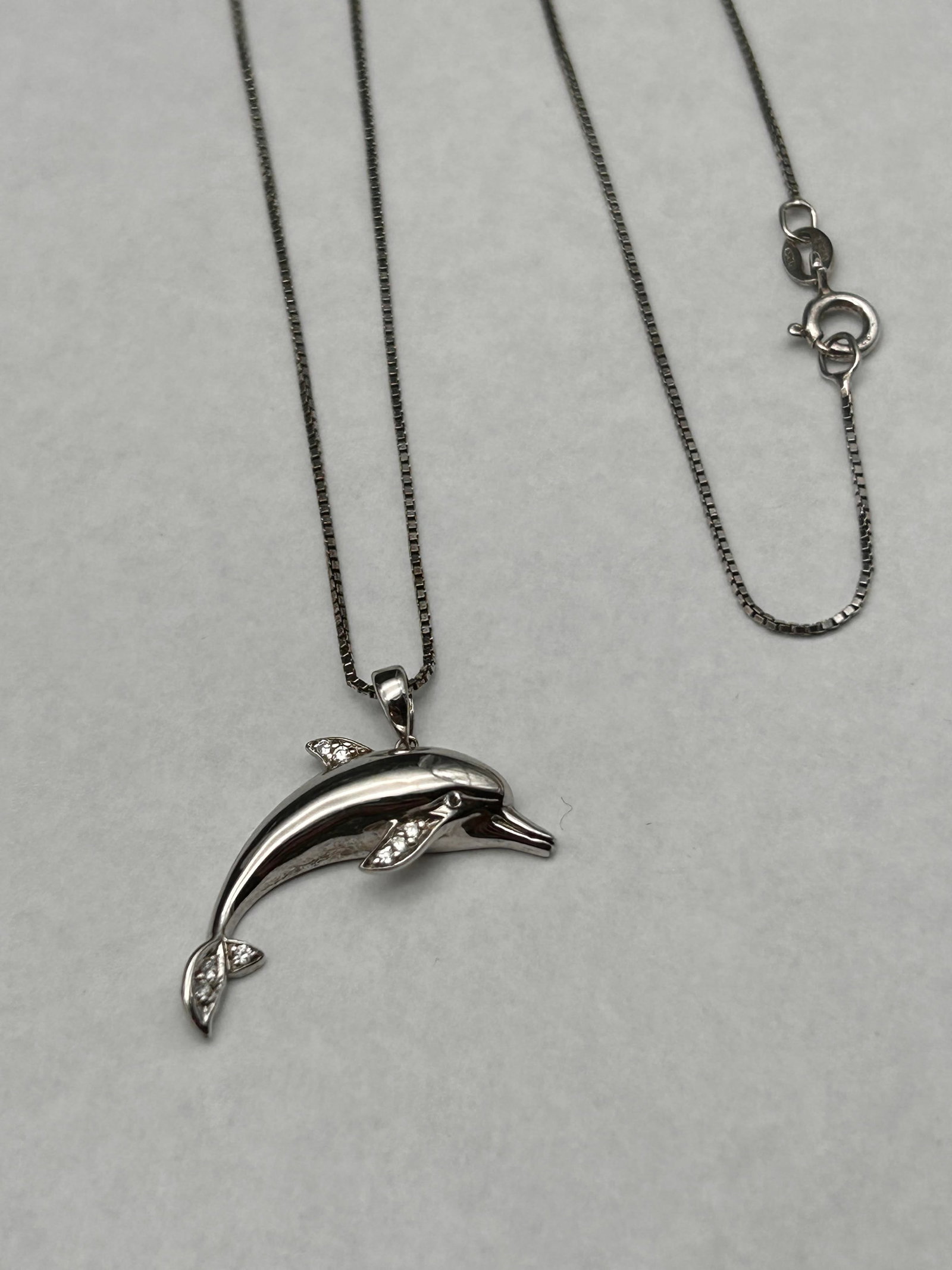 Chrome Finish Sterling Silver Dolphin Pendant, Small CZ Stones, 18" Sterling Box Chain, Marked 925: Bidding on this item will be indication that the Bidder acknowledges that they have read and agreed to the Terms and Conditions posted to this Auction