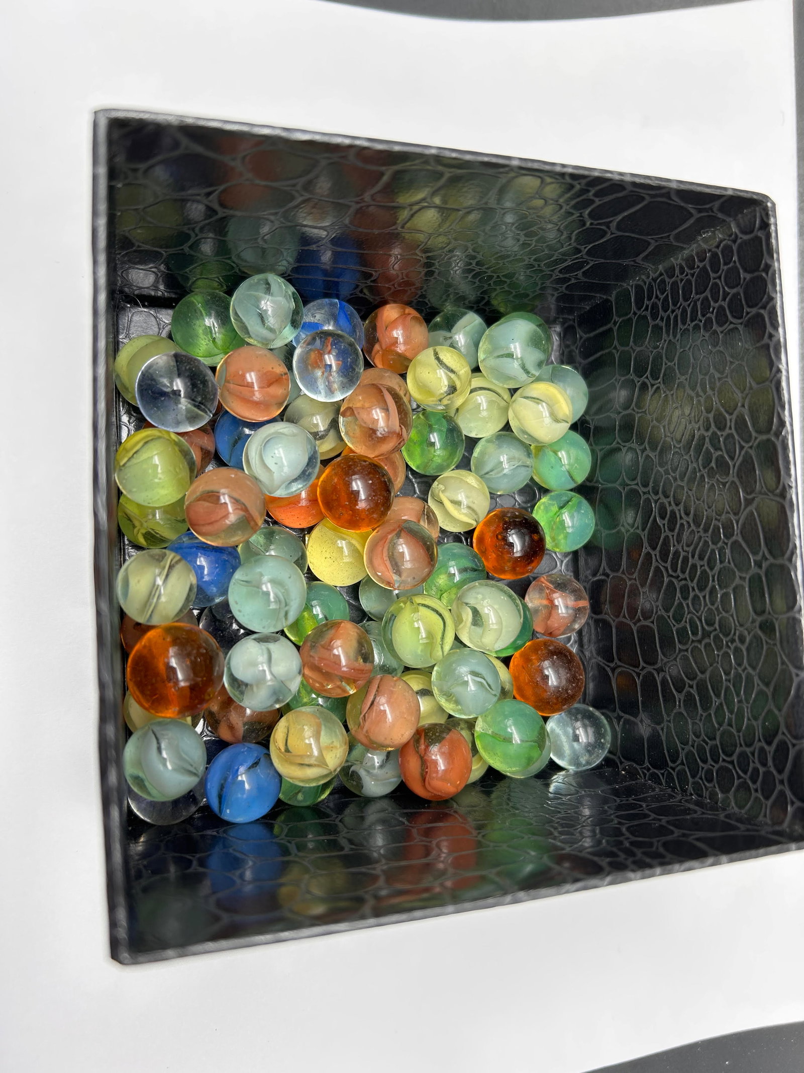Glass Marbles, Swirled Colors, In Faux Snakeskin Felt Lid Box, 4.5" x 4.5": Bidding on this item will be indication that the Bidder acknowledges that they have read and agreed to the Terms and Conditions posted to this Auction