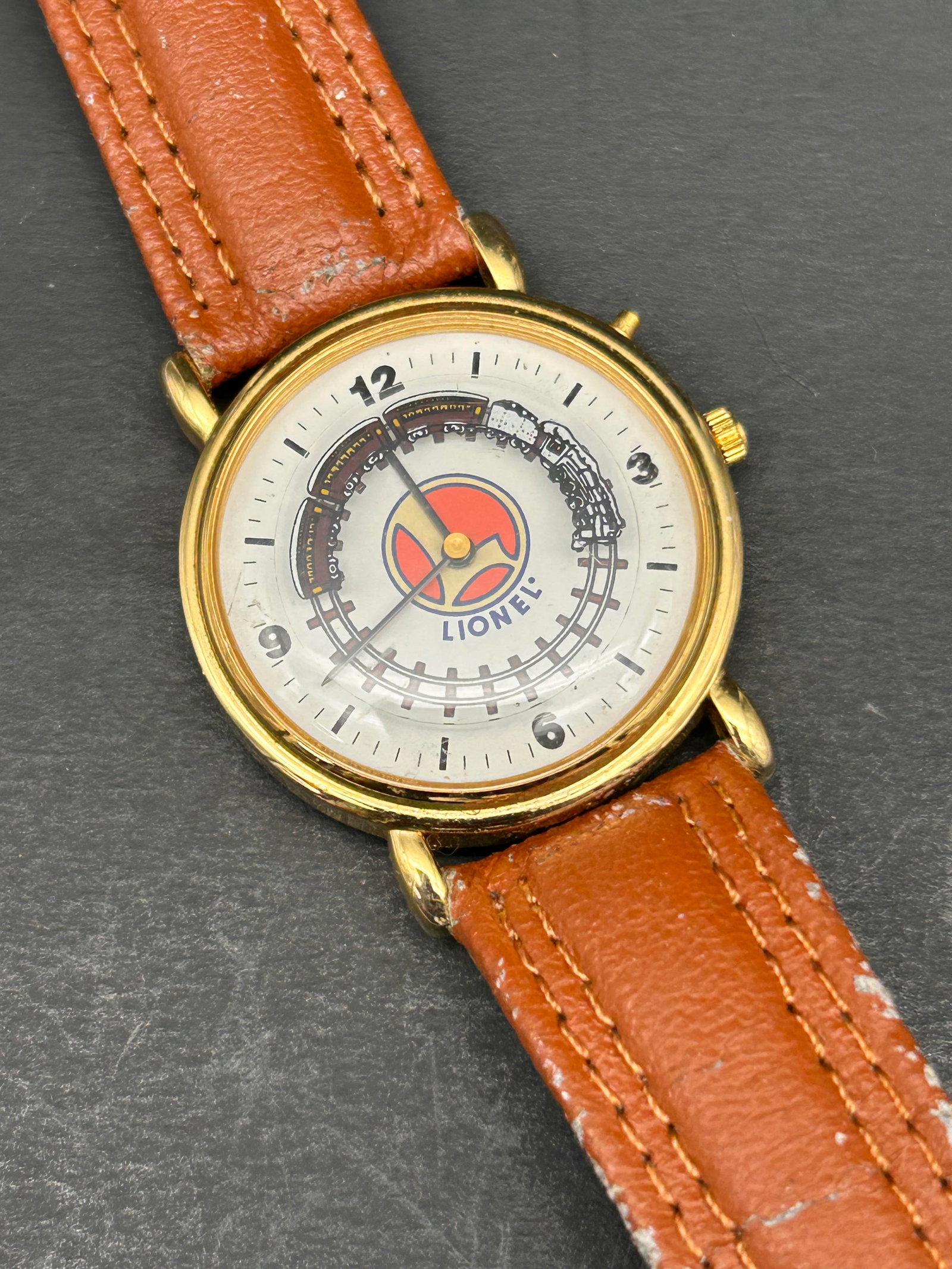 Lionel Collectible Train Watch, Tan Band With Moving Train, Band Shows Wear, Needs Battery: Bidding on this item will be indication that the Bidder acknowledges that they have read and agreed to the Terms and Conditions posted to this Auction