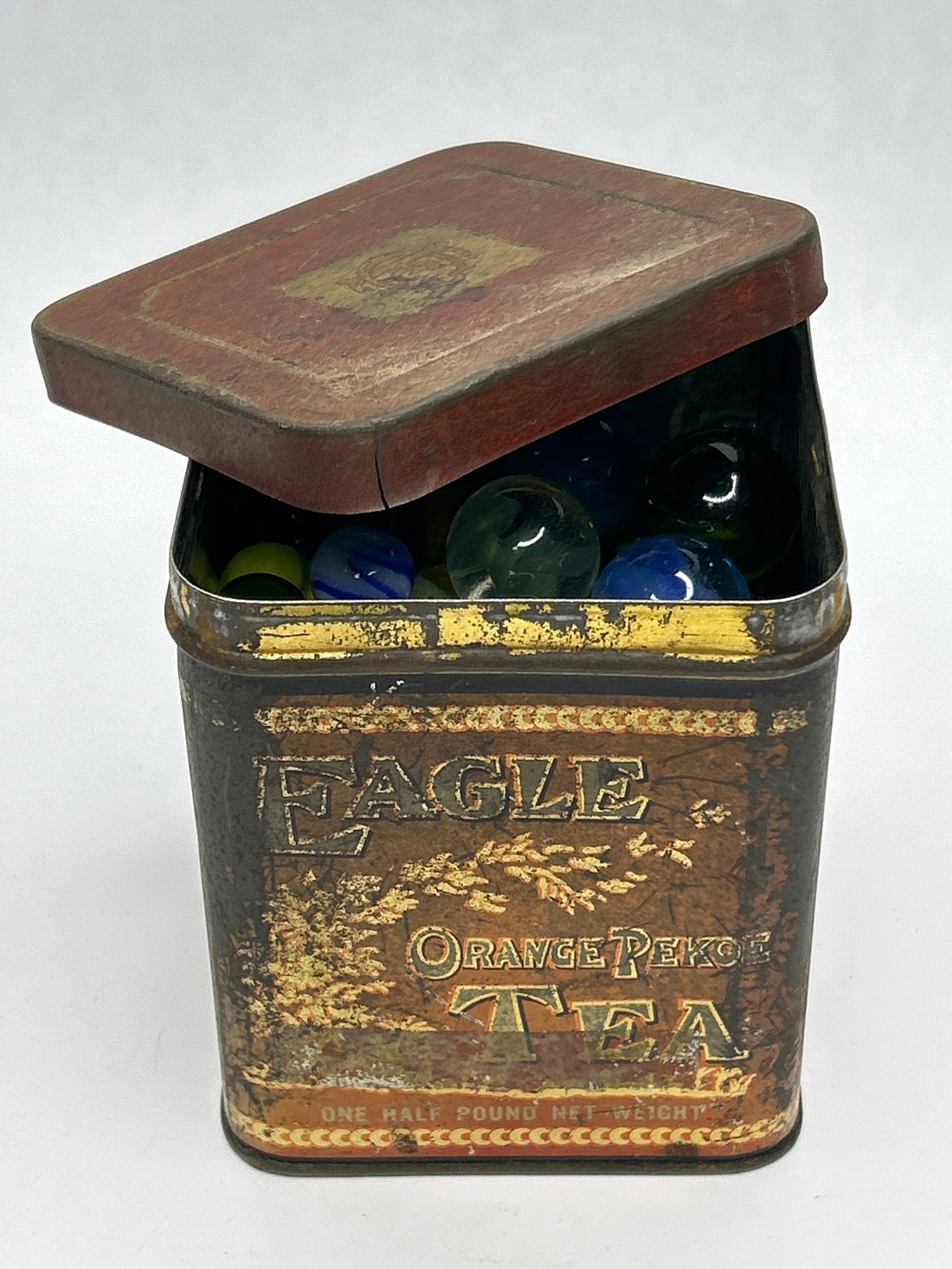Over 2 Pounds of Glass Marbles in Vintage Eagle Tea Tin: **Bidding on this lot is acceptance of Terms & Conditions found in the Auction Details section at the top of our Auction. Bidder agrees all questions should be submitted prior to placing a bid.**