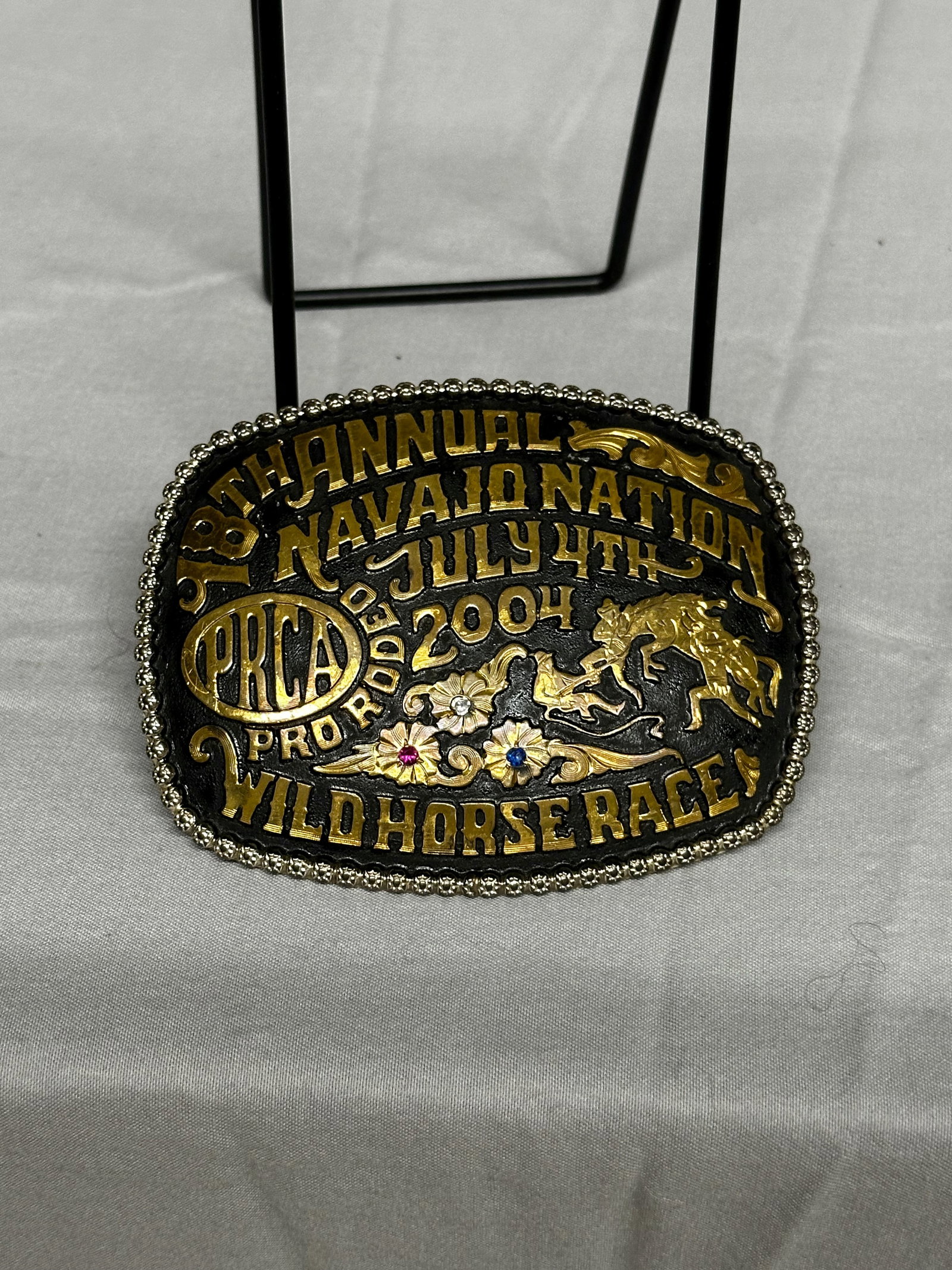 18th Annual Navajo Nation Pro Rodeo Wild Horse Race Buckle: 18th Annual Navajo Nation Wild Horse Race July 4th Pro Rodeo Please take a moment to review our detailed Shipping Policy and Terms and Conditions before placing any bids. Understanding these policies 
