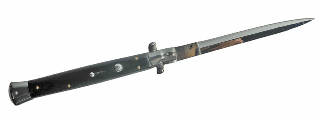 Italian Switchblade (A): A straight-bladed Italian Switchblade in very good condition. The knife measures 13" Open and 7.25 closed. The mechanism appears to work properly. Marked "China".