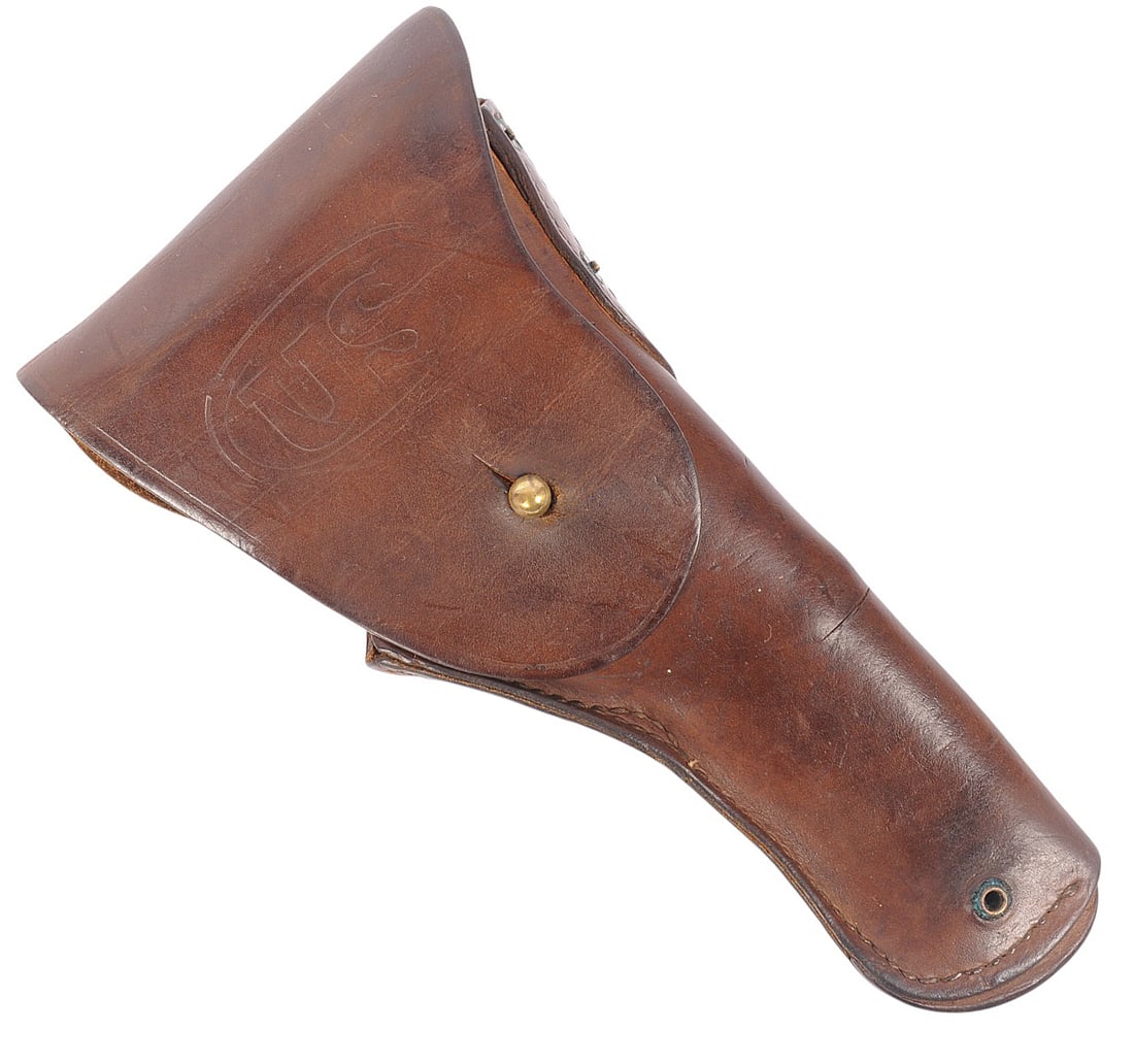 US Military WWII era Leather M-1917 Revolver Holster(M2T): A US Military WWII era Leather M-1917 Revolver Holster is in very good condition with the soldier's name inside it. The leather has minor cracking with some discoloration from age.