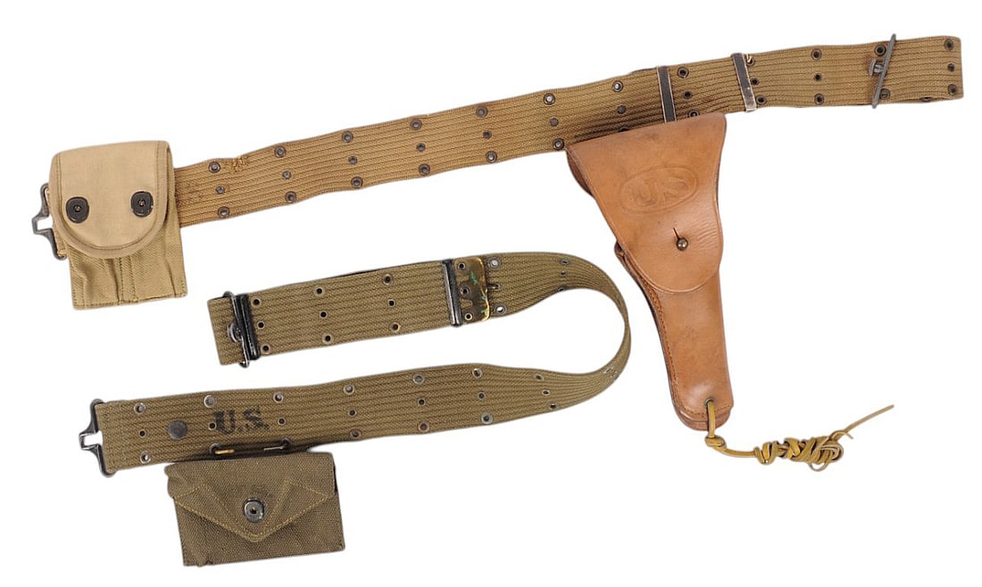 Two US Military WWII era Pistol Belts (M2T): A Lot of Two US Military WWII era Pistol Belts, one with a Dressing pouch and one with a Sears 1942 Holster and a Magazine Pouch in good to very good condition. All pieces have minor wear with some fr