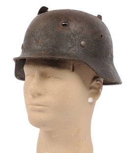 *German Military WWII issue M40 Battle-Damaged Helmet (J): A *German Military WWII issue M40 Battle-Damaged Helmet in fair condition with damaged liner. Helmet shows traves of sand-camo finish, and bullet/shrapnel damage. 