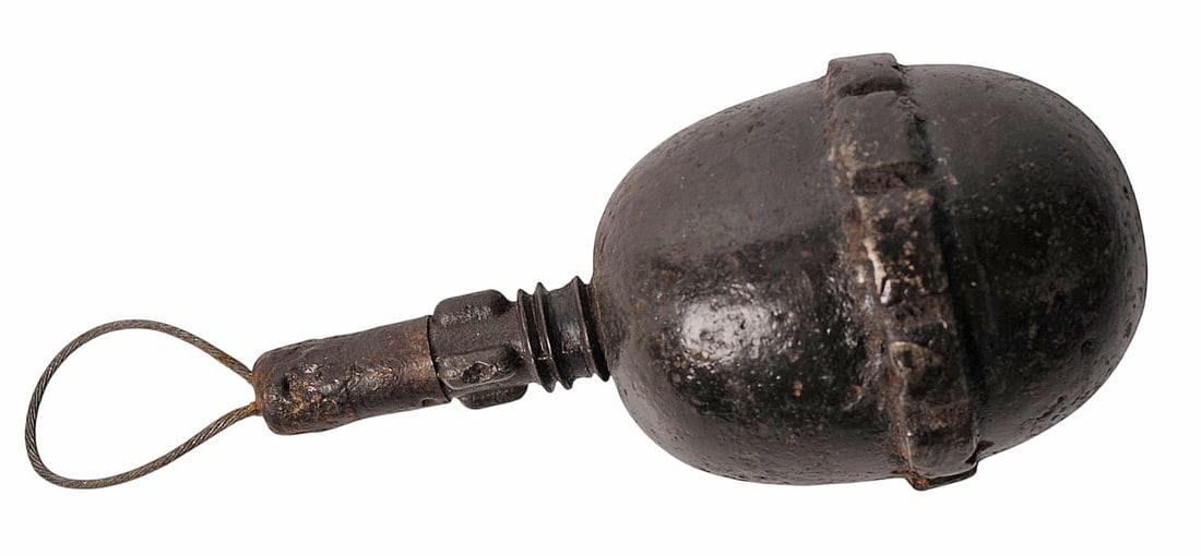 Inert German WWI Inert M1917 Egg Grenade (H3S): An Inert German WWI Inert M1917 Egg Grenade with fuse in good to very good condition. The grenade has the original actuation lanyard.