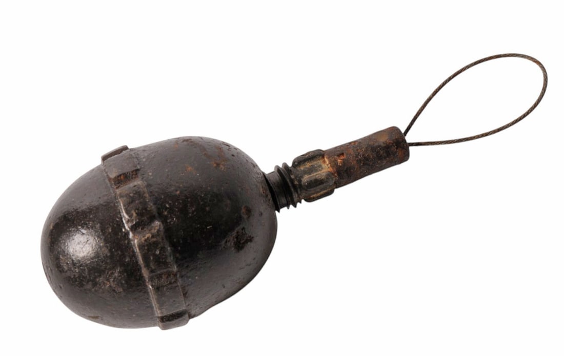 Inert German WWI Inert M1917 Egg Grenade (C44P): An Inert German WWI Inert M1917 Egg Grenade with fuse in good to very good condition. The grenade has the original actuation lanyard.