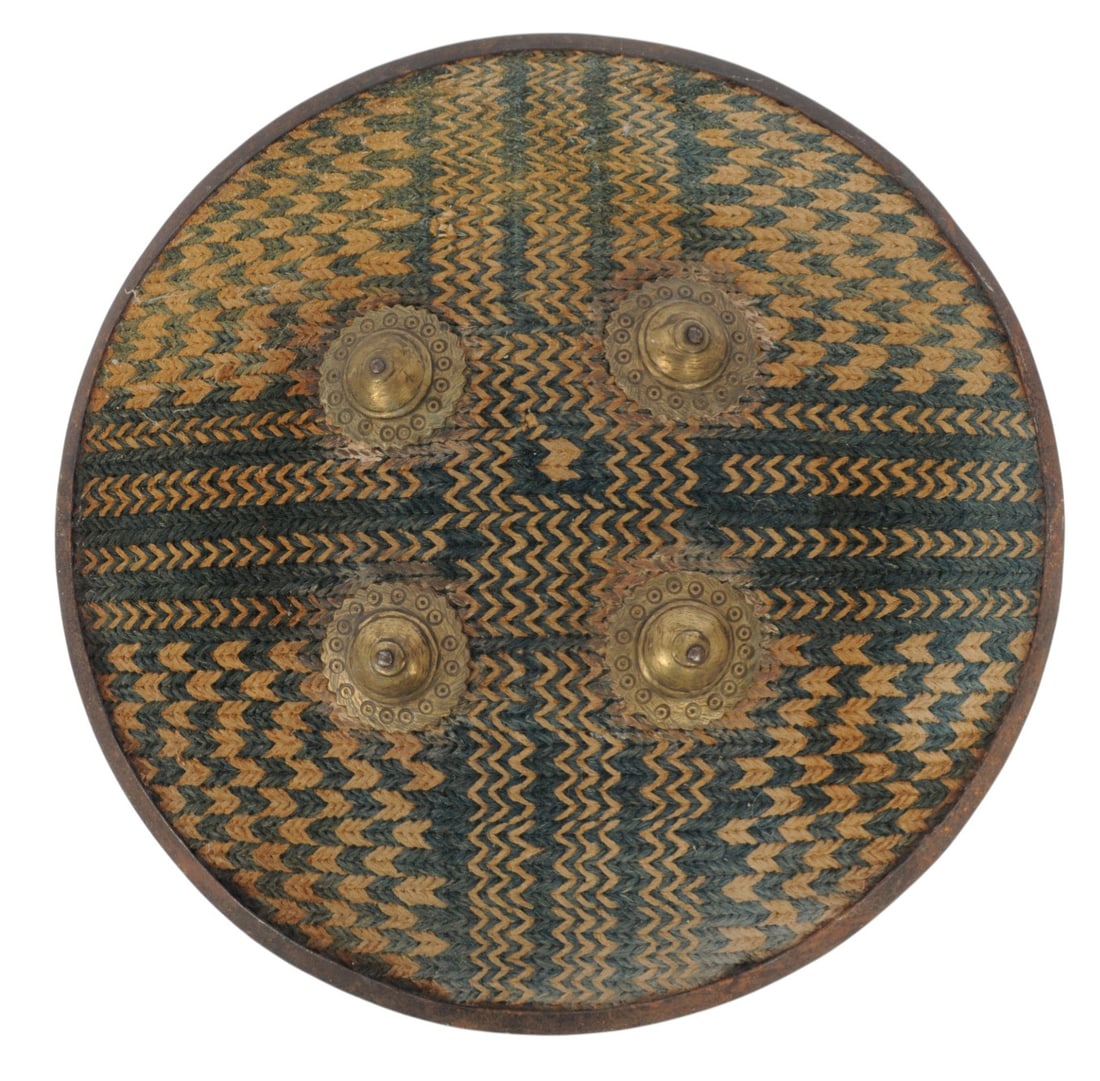 Indo-Persian 15th Century Warrior Shield (A): An unusual fabric-covered steel Indo-Persian 15th Century Warrior Shield in good to very good condition. It measures __" across. 