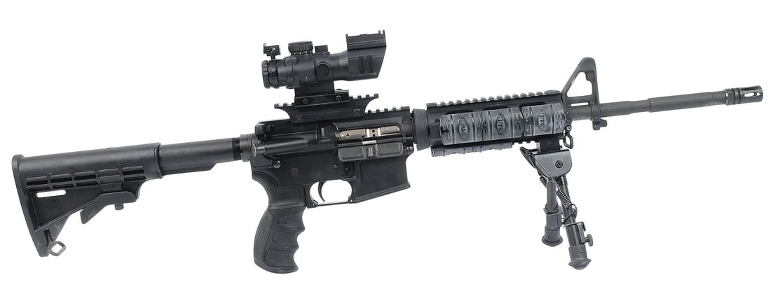 Bushmaster XM15-E2S 5.56mm Semi Auto Rifle with Sniper "ACOG" Style Scope FFL AMG500255 (A2R1): A Bushmaster XM15-E2S 5.56mm Semi Auto Rifle with Sniper "ACOG" Style Scope in good to very good condition with a bright and defined bore. The action appears to function properly with minor wear to th