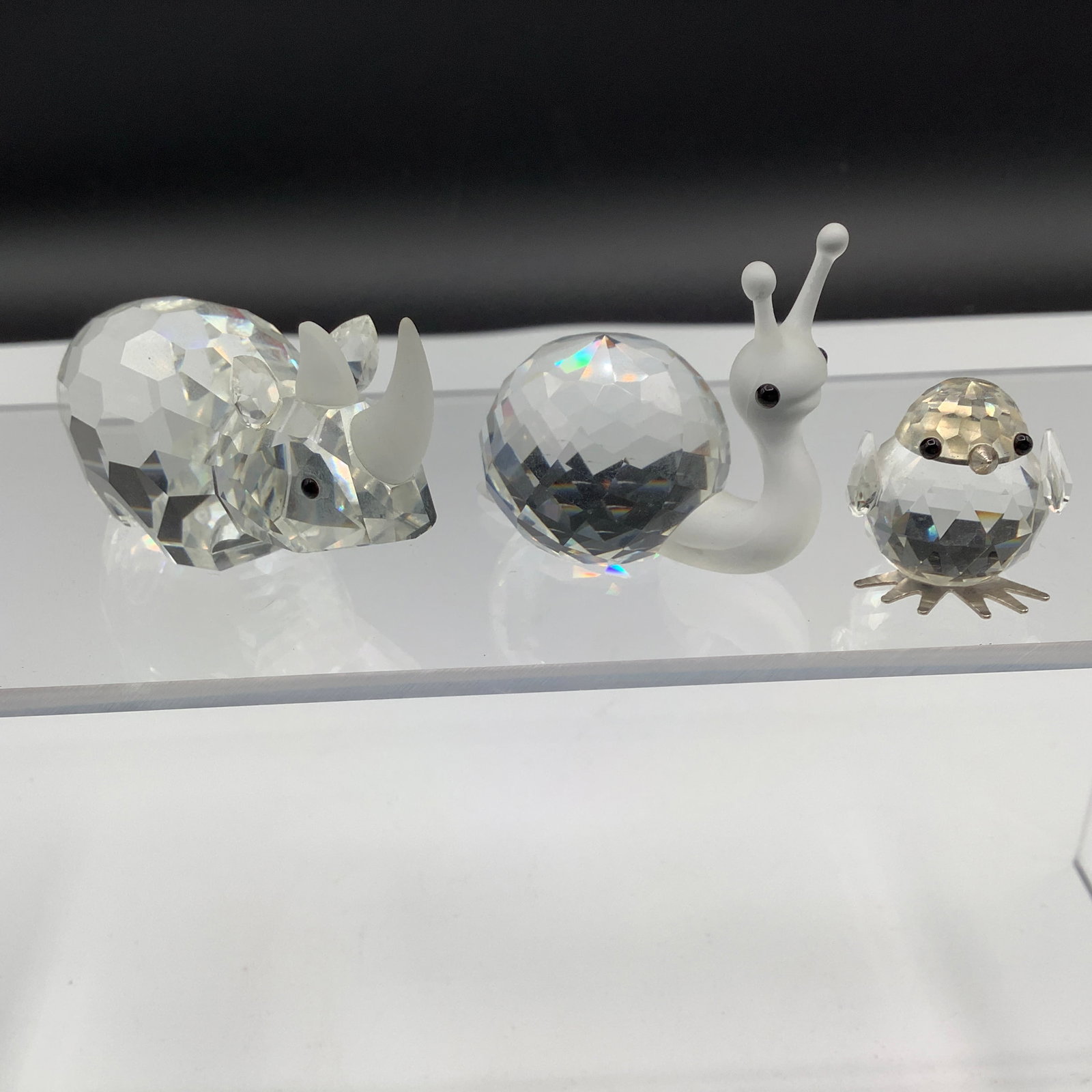 Swarovski Crystal Rhinoceros, Snail and Chick: Swarovski Snail has frosted head and is 1.75 inches long Rhinoceros is 2.75 inches long Chick has black eyes, silver beak and silver feet. Chick has old Swarvoski mark on the metal feet and is about .