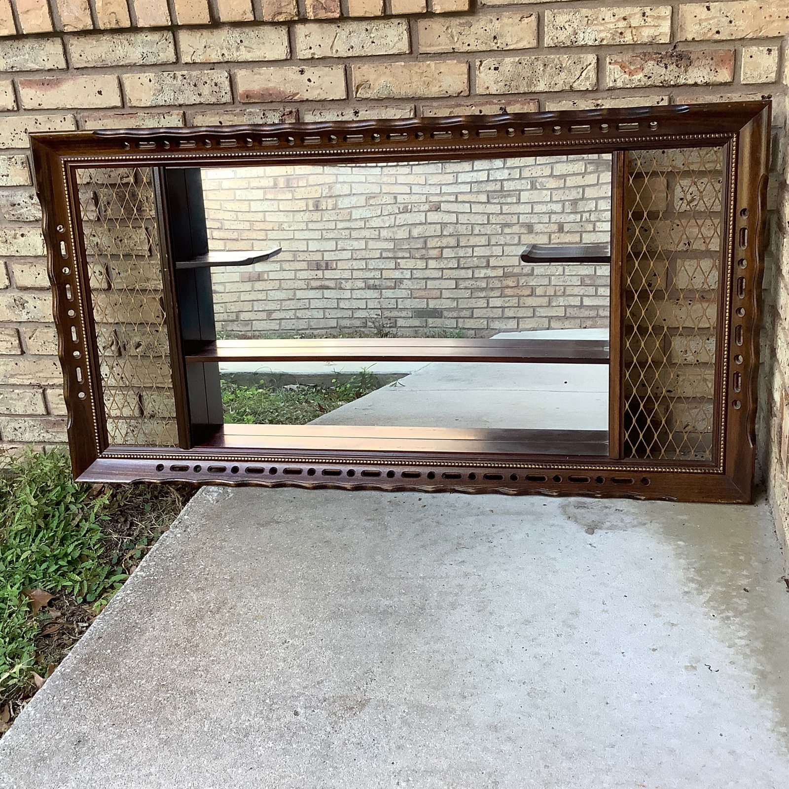 Vintage Mid Century Turner Shadowbox Mirror w/ Curio Shelves: Mid Century Turner Accessory shadowbox Mirror backing in center with one long shelf, 2 smaller side shelves Metal mesh side accents, cut outs and rope design