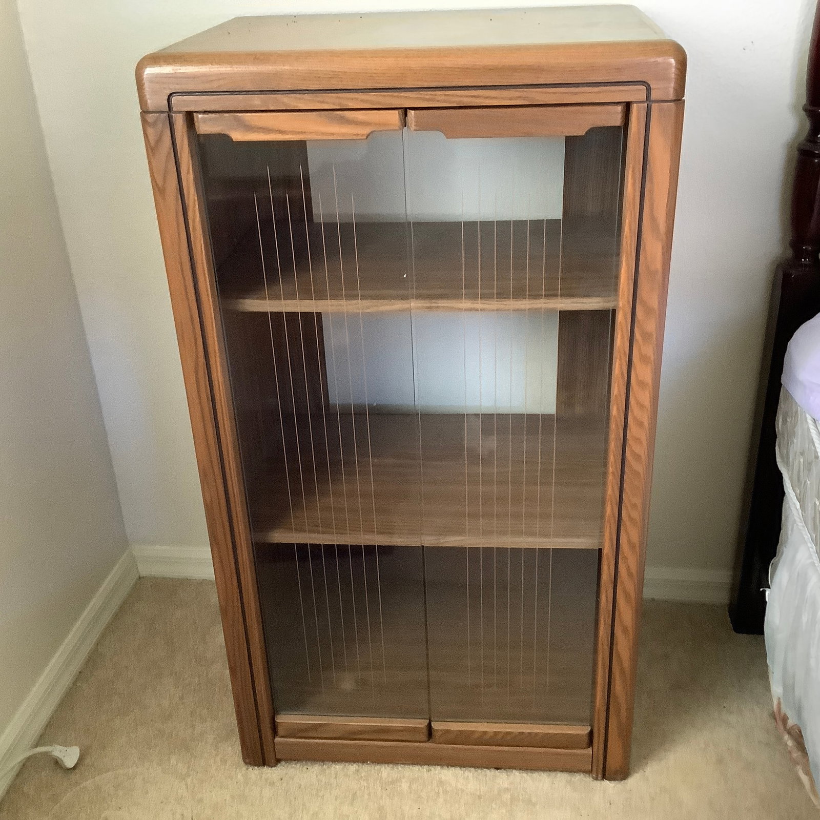 Vintage Mid Century Music Cabinet with Line Design on Doors: Oak wood cabinet with 2 glass doors Front of doors etched gold vertical line design All rounded corners and has 2 wood shelves