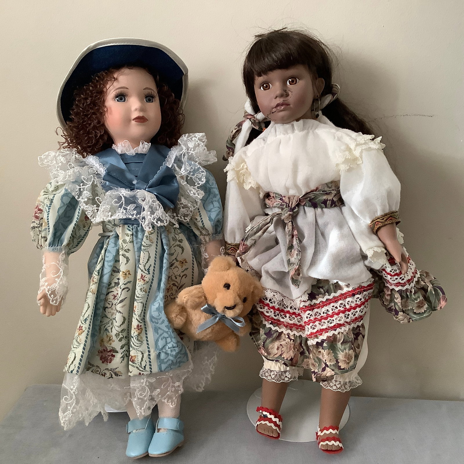 2 15 inch Dolls, One Dynasty Doll Collection: Dynasty doll has a strap loose on one shoe and she has a mark on her face