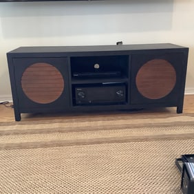 Black Media Cabinet with Circular Wood Slat Accents on Doors