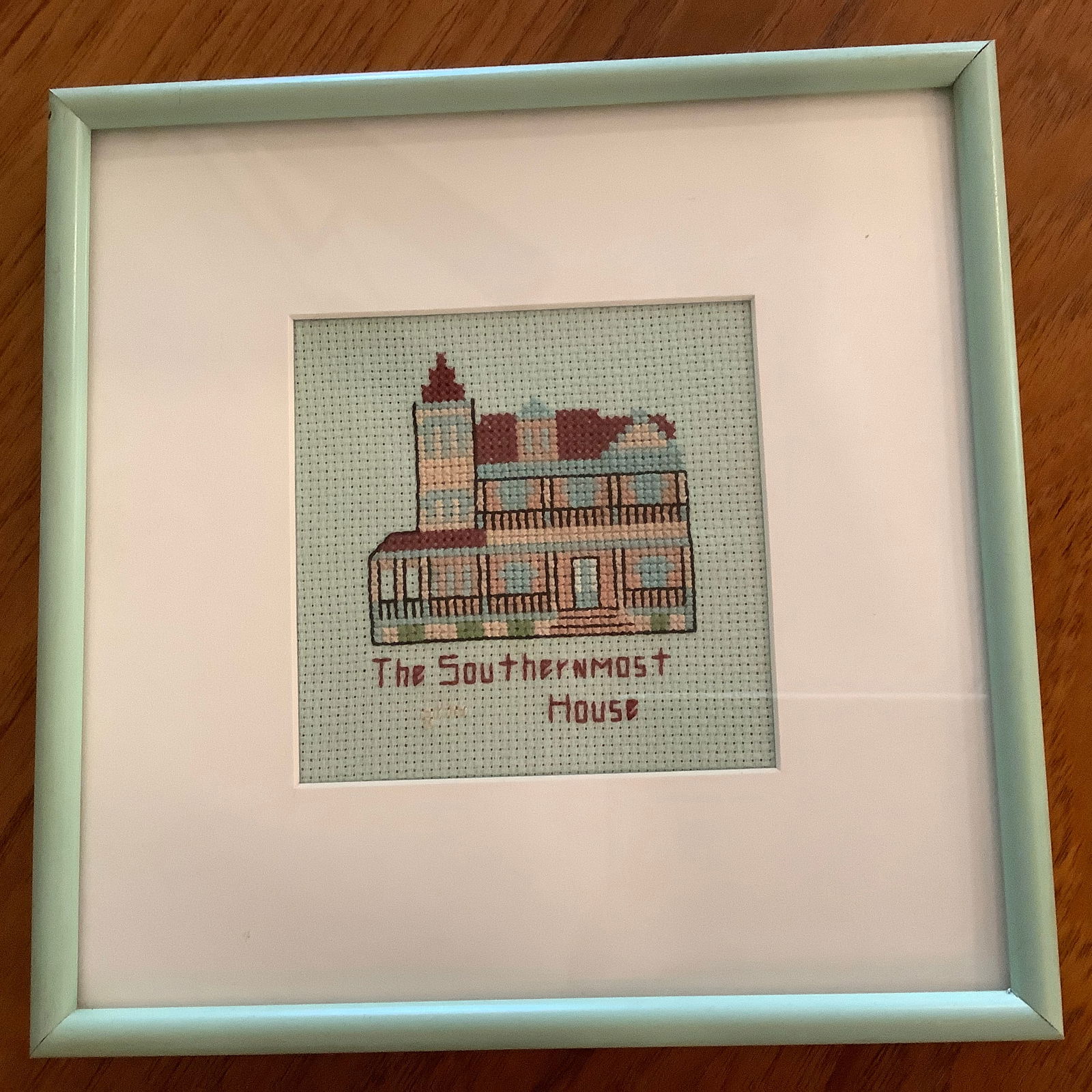 Framed Needlepoint of "The Southernmost House": Mint green background and mint green framing