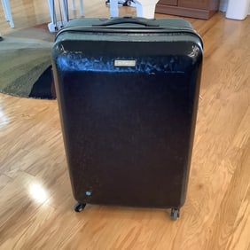 American Tourister Rolling Suitcase with Exterior in Black and Blue Reflective