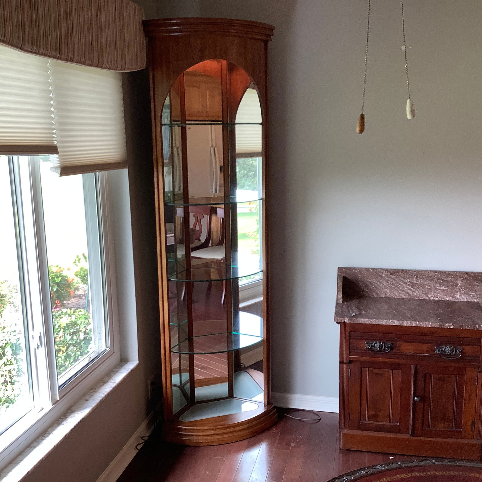 Lighted Corner Open Curio with Bowed Front, Arched Wood Opening, Mirror Back, Glass Shelves: Back and sides have mirrors Glass shelves Top rounded crown molding Lighted on top and bottom(bottom not working)