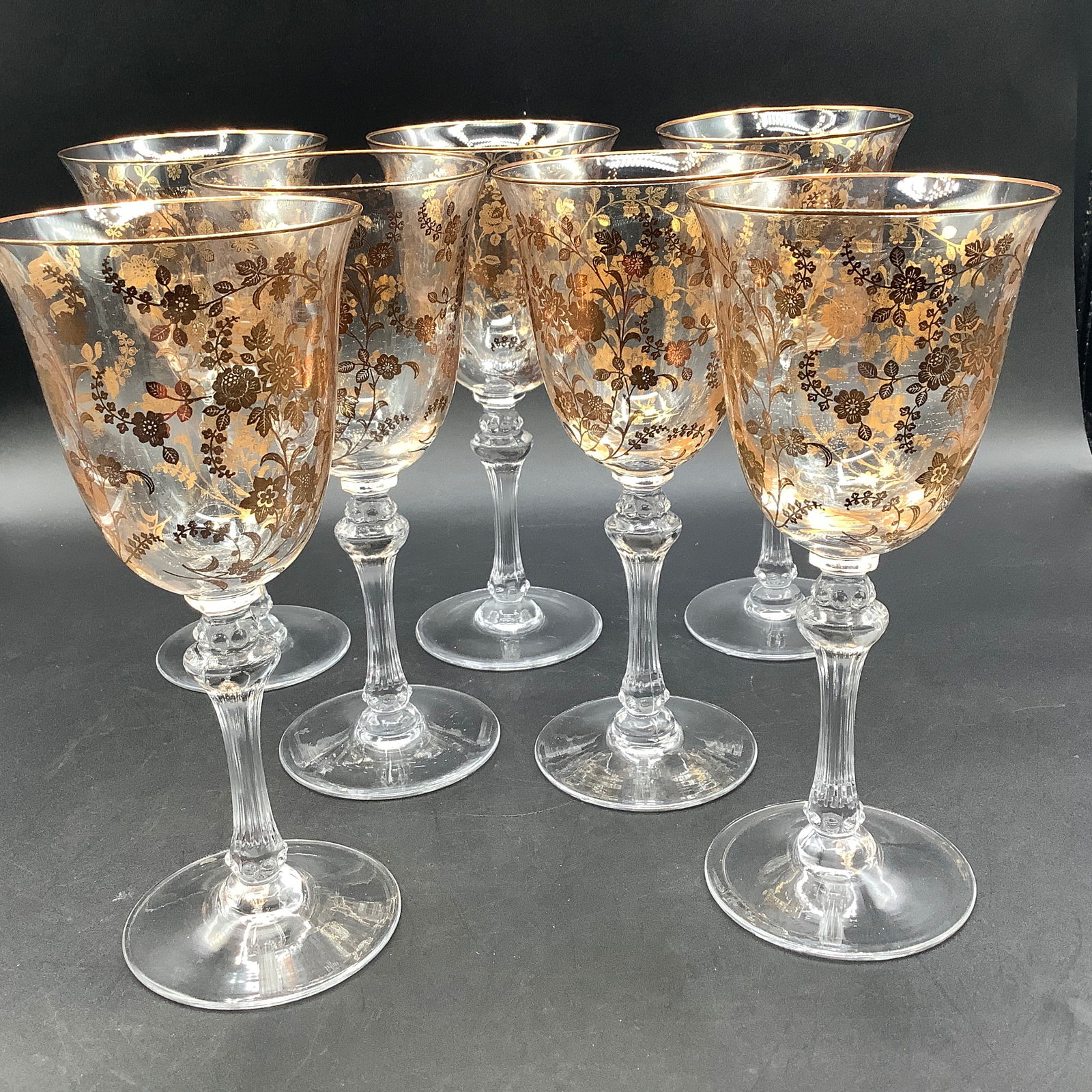 Set of 7 Tiffin Signed Water Goblet Glasses with Gold Etched Flowers: Fluted stems, etched Tiffin on underside Gold rim and gold flowers