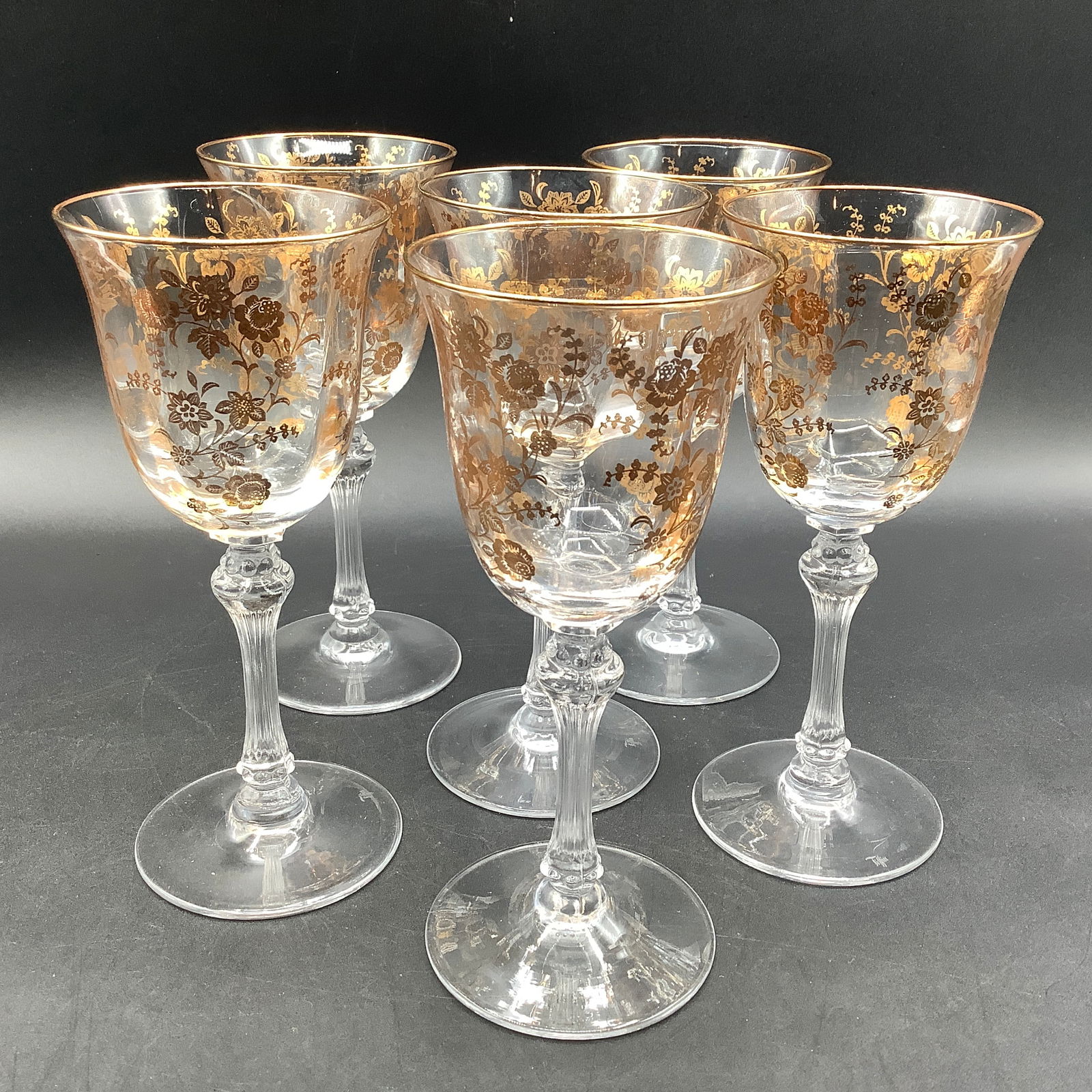 Set of 7 Tiffin Signed Wine Glasses with Gold Etched Flowers: Fluted stems, etched Tiffin on underside Gold rim and gold flowers