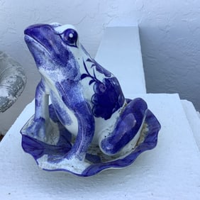 Blue and white porcelain frog on a lilypad