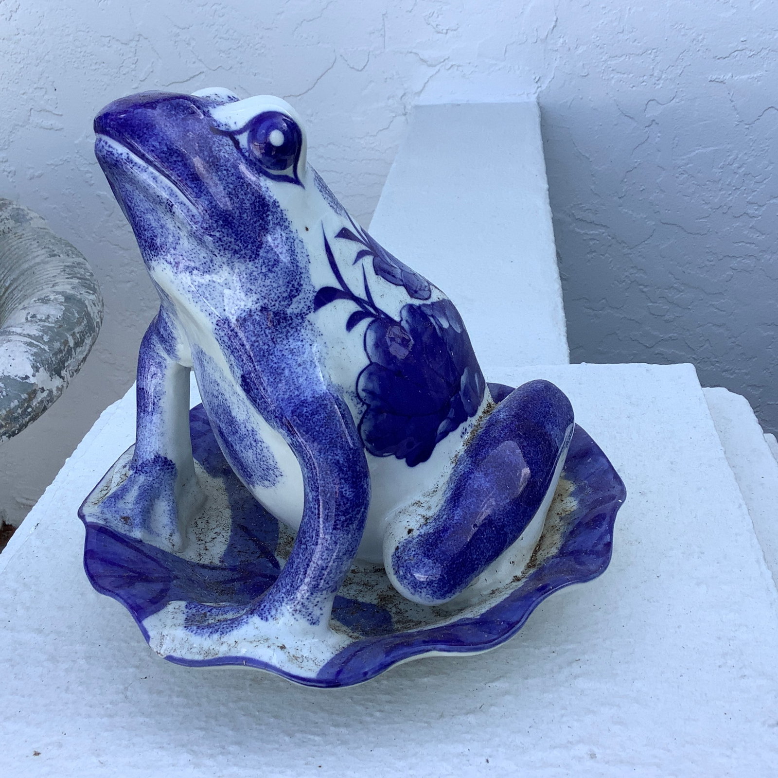 Blue and white porcelain frog on a lilypad: 4 Character mark on underside No apparent chips/cracks He has spent some time outdoors on a patio and could use cleaning if brought indoors