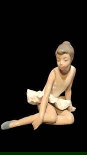 NAO by Lladro Sitting Ballerina Figurine: NAO by Lladro handmade, porcelain ballerina figurine. In good used condition, with minor scuffs on bottom. 6 1/2" H x 6 1/2" W. 6 lbs