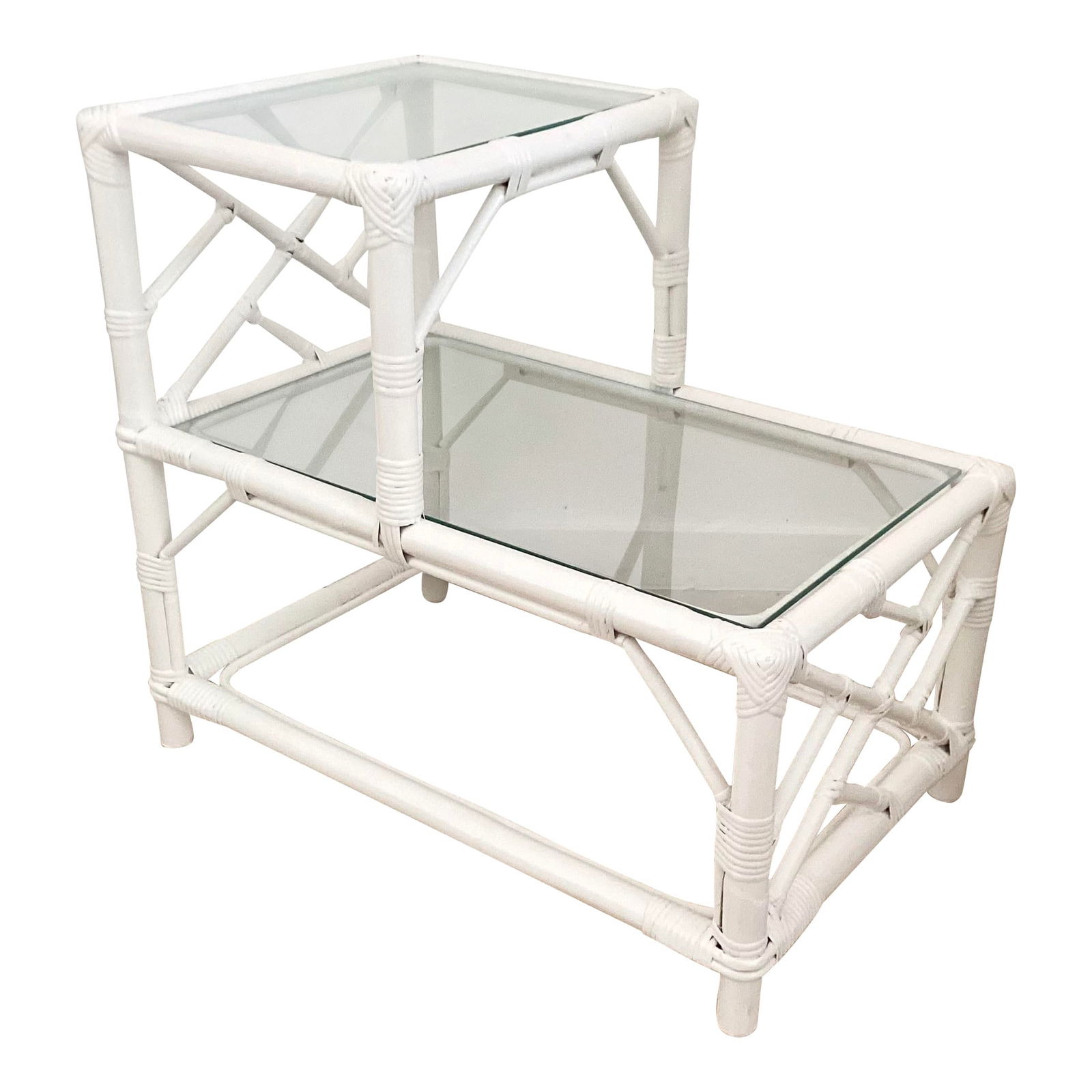 Ficks Reed Tier Rattan Table: 27"W × 17"D × 24"H Boho Chic Ficks Reed rattan tier side table lacquered in white with glass tops. Made in the 1960s. We have a similar table in our listing so collect both.