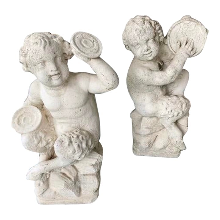 French Cast Stone Pan and Putti Musician Sculptures, a Pair: 16"W × 12"D × 28"H 1950s pair of French cast stone Pan and Putti musician sculptures. We have two pairs available in stock. Made in France.