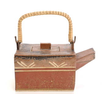 RON TAYLOR Studio Art Pottery Teapot: A studio art pottery teapot by listed Kansas City artist Ron Taylor. Wicker wrapped handle. Stamped RT on base. Dimensions: H:5.5” x L:4” x W: 3.5”