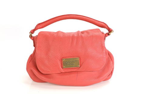 MARC By MARC JACOBS Designer Handbag: A coral colored leather Marc Jacobs designer handbag. The interior is a black and white Marc Jacobs logo print. Measures 13” x 7”.