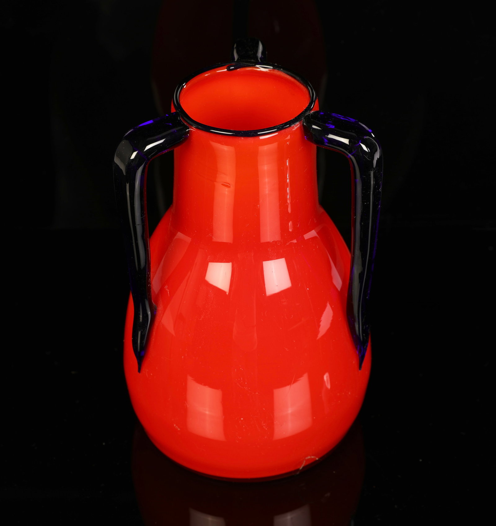 LOETZ TANGO RED W/ BLUE HANDLES CZECH GLASS VASE ART DECO: A Loetz Art Deco period red glass vase with three blue glass handles. Signed on base: Czechoslovakia. As pictured. No damage noted. Measurements:7.5" x 4.75"(diameter at wides point)