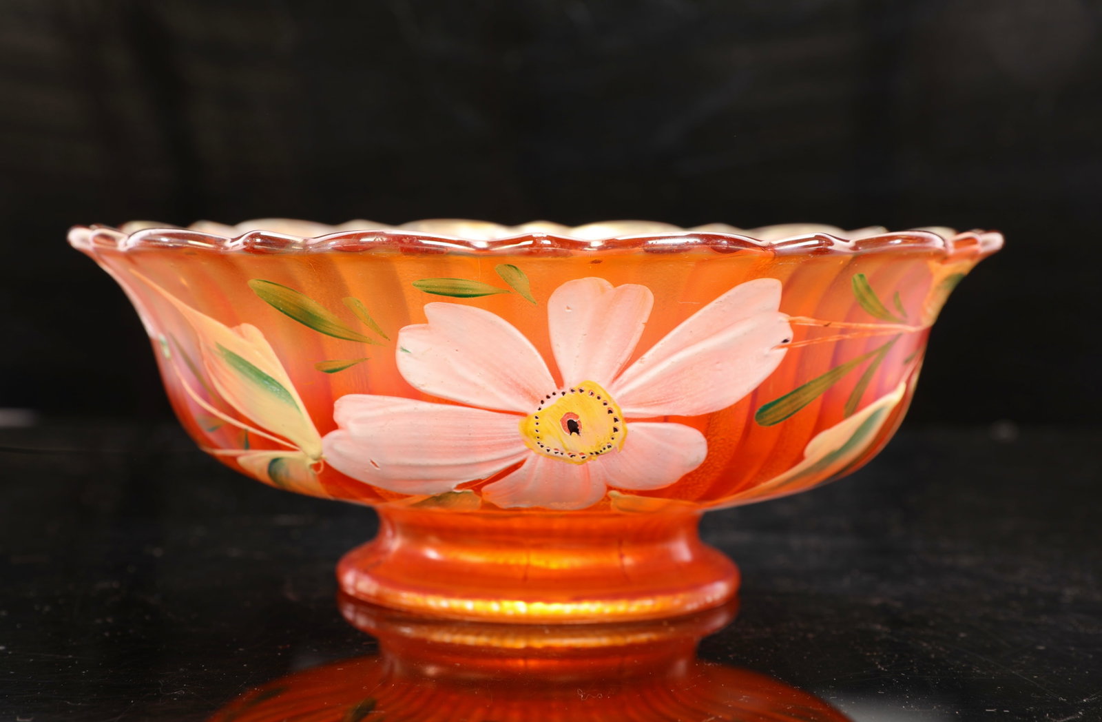 MARIGOLD CARNIVAL GLASS BOWL W/ PAINTED FLOWERS: A marigold carnival glass bowl with scalloped edges and hand-painted flowers. As pictured. There is a crack in the base. See close up photos. Measurements:3.5"H x 9" diameter